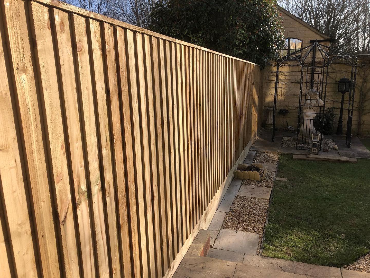 Timber fence beside a garden path