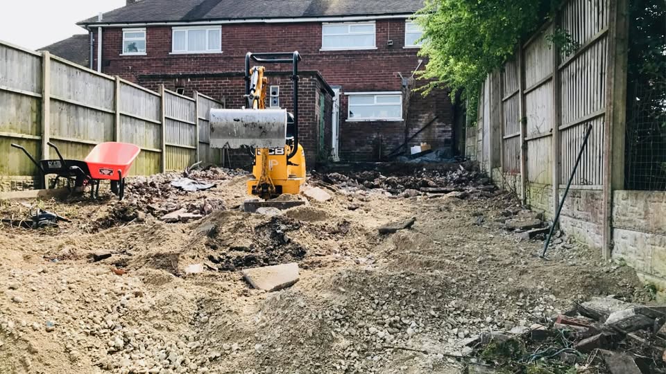 Digger and cleared ground during garden fencing work